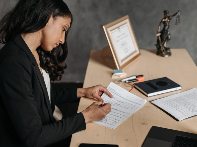 Contract Design for In-House Counsel A photo of a lawyer working on a contract.