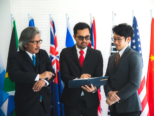 International in-house lawyer A group of in-house lawyers in a modern office discussing international legal matters, highlighting cross-border collaboration and contract negotiation