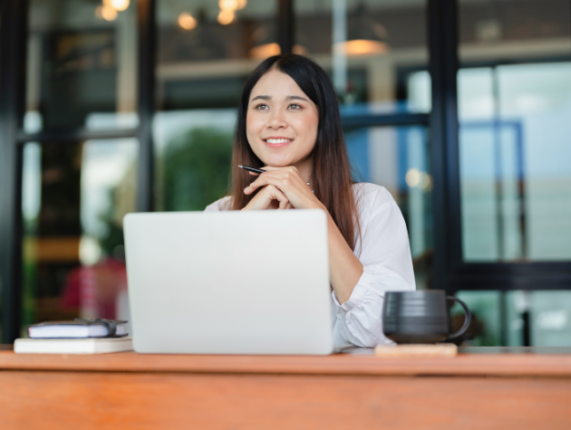 Mindfulness and Wellness for In-House Lawyers A calm in-house lawyer practicing mindfulness at her desk, symbolizing the integration of wellness into the legal profession.