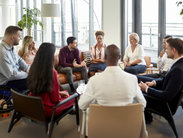 lawyer_connecting_with_team_through_storytelling legal storytelling for in-house counsel: A lawyer is engaged in a conversation with a group of colleagues, conveying a sense of collaboration and shared understanding.