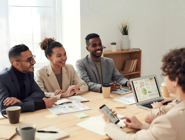 Female general counsel mentoring diverse legal team in modern office