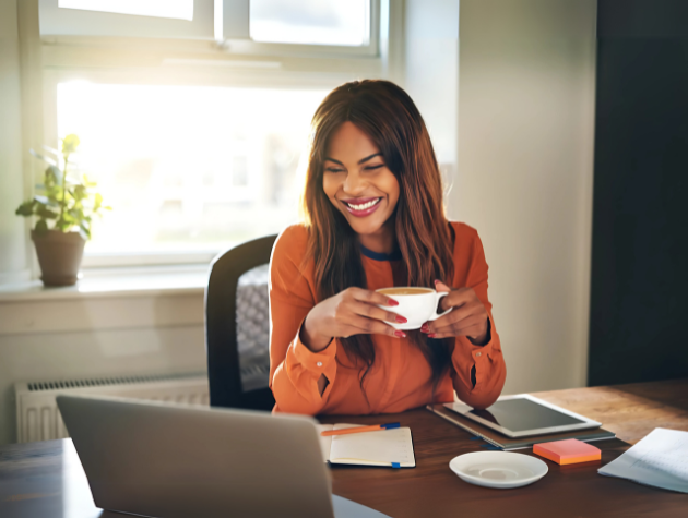 Senior in-house lawyer working from home, smiling confidently in a calm workspace that reflects career and personal balance