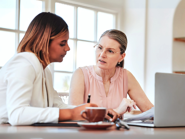 In-house legal professional in a leadership coaching session with a mentor in a modern office