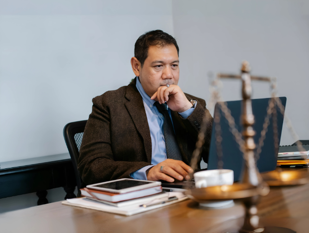 In-house lawyer using an AI-powered legal research platform to search case law with natural language on a laptop