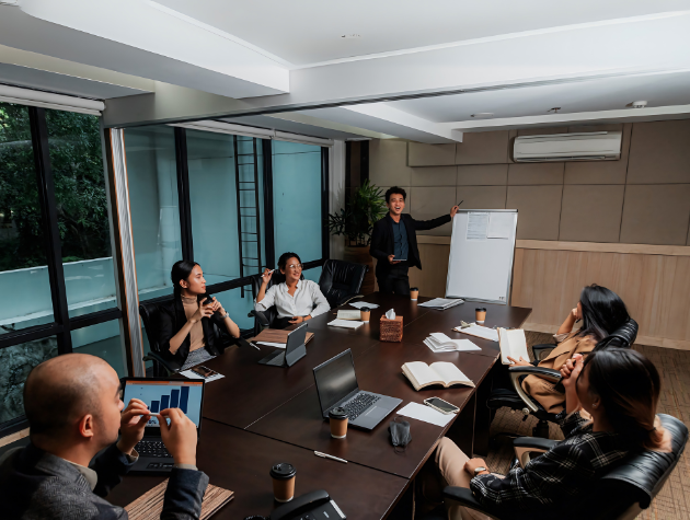 In-house legal team reviewing AI dashboard during a post-deployment strategy meeting