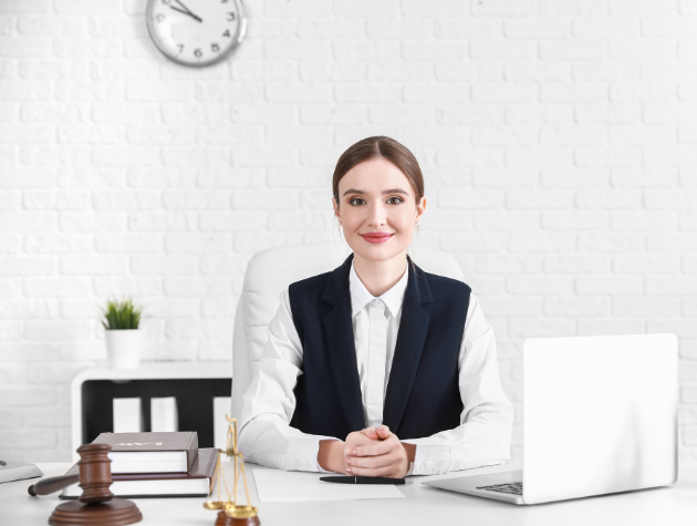 Confident in-house lawyer at her desk with legal books, scales of justice, and a laptop, symbolizing AI integration in legal work.