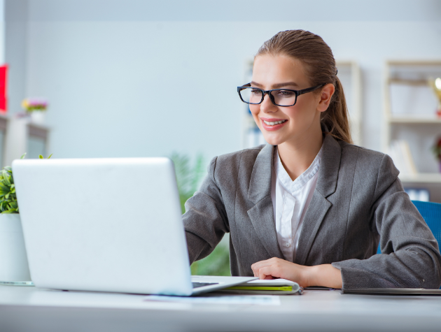 Smiling legal professional in a gray suit reviewing AI-generated legal data on a laptop, symbolizing trust, transparency, and data provenance in legal AI.