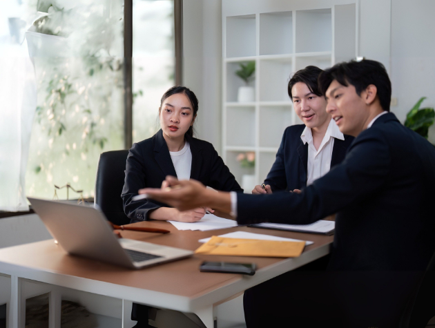 A group of legal professionals in a business meeting discussing AI strategy and corporate governance.