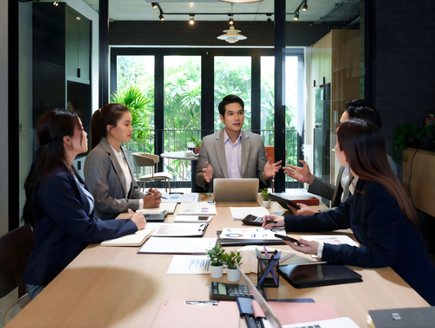 In-house legal professionals collaborating in an office while discussing AI and sustainability considerations.